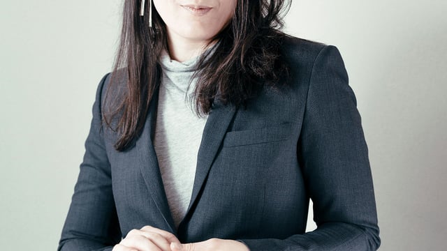 A Chair woman in blazer smiling at the camera 1