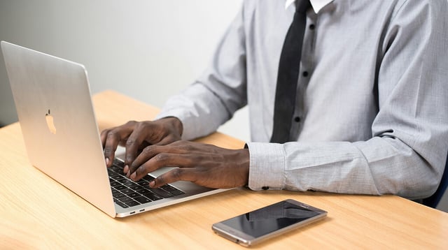 Man using laptop, one of the essential skills of directors in the boardroom 1 (1)